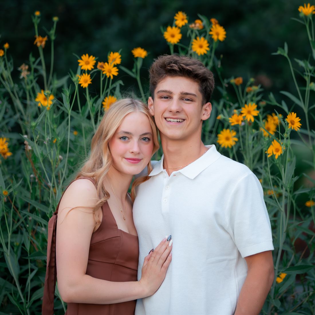 Couple posing together among yellow flowers